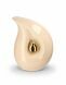 Teardrop cremation urn for ashes made of beige ceramic with small gold-colored teardrop