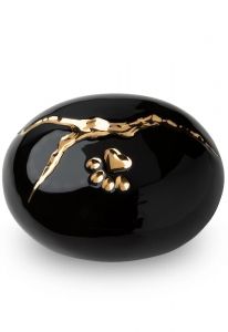 Black pet urn 'Kintsugi' with gold-colored paw