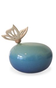 Handmade green-blue ceramic funeral urn with wooden butterfly