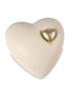 Beige cremation urn for ashes with gold colored heart