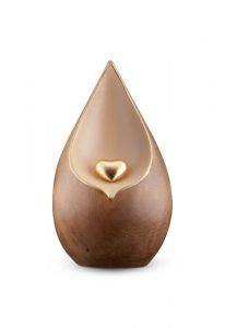 Teardrop cremation urn for ashes with gold-colored heart made of double-stained limewood