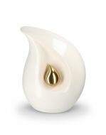 Teardrop cremation urn for ashes made of white ceramic with small gold-colored teardrop